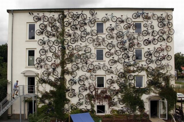 Co-owner Christian Petersen walks up the stairs as he poses for the media at his bicycle shop in Altlandsberg, north-east of Berlin, August 17, 2010. The owners attached about 120 bicycles on the facade to advertise their shop. REUTERS/Fabrizio Bensch (GERMANY - Tags: SOCIETY ODDLY)